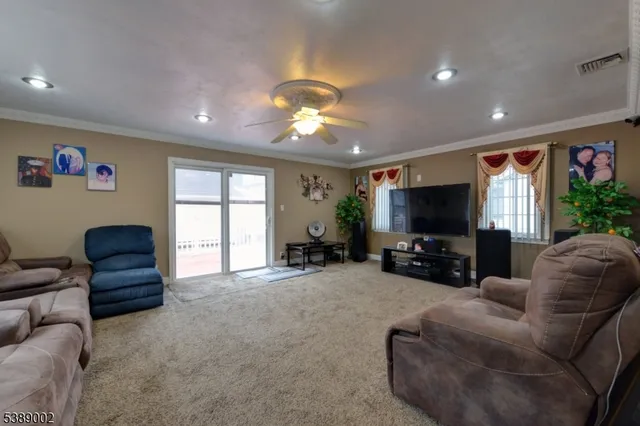 a living room with furniture a large window and a flat screen tv