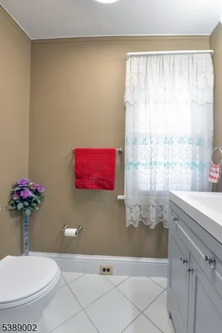 a bathroom with a granite countertop sink a toilet and bathtub