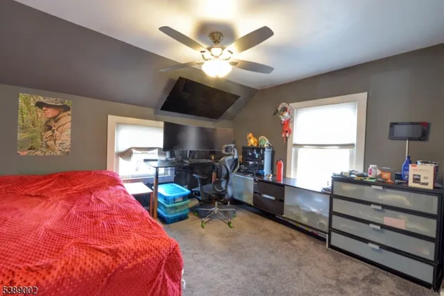 a bed room with a bed and a chandelier