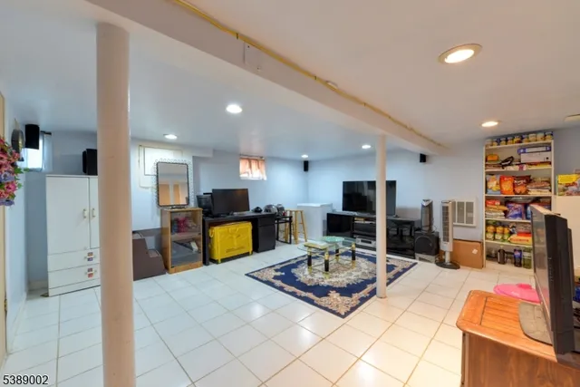 a living room with furniture kitchen view and a flat screen tv