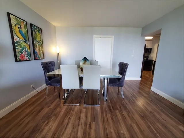a view of a dining room with furniture and wooden floor