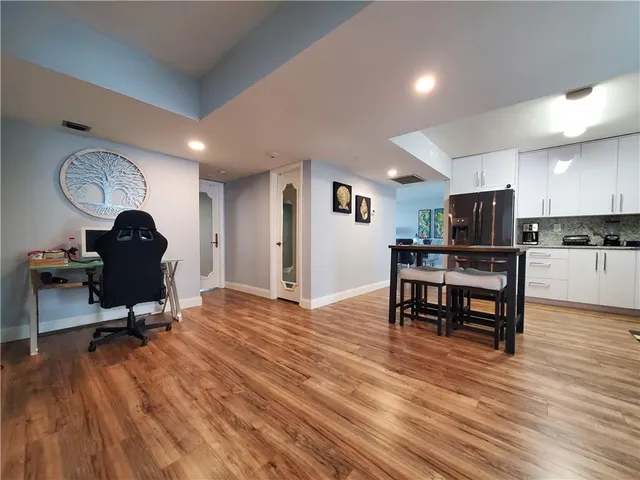 a view of a kitchen with workspace and wooden floor
