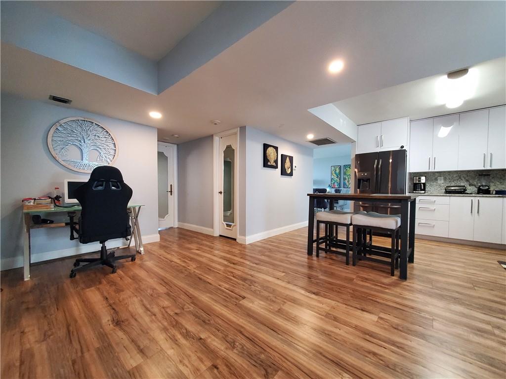 1401 North Riverside Drive, Unit 1503 Pompano Beach, FL 33062 - Photo 18 of 34 a view of a kitchen with workspace and wooden floor