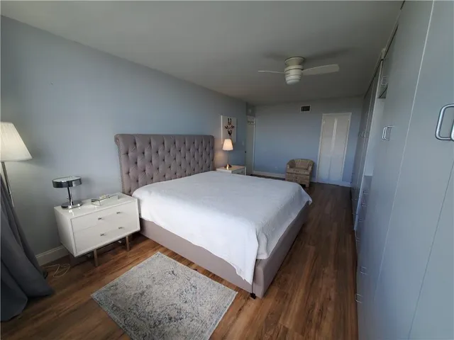 a large bed sitting in a bedroom next to a window