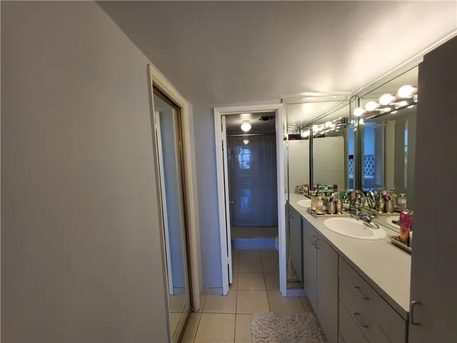 a bathroom with a sink vanity and a mirror