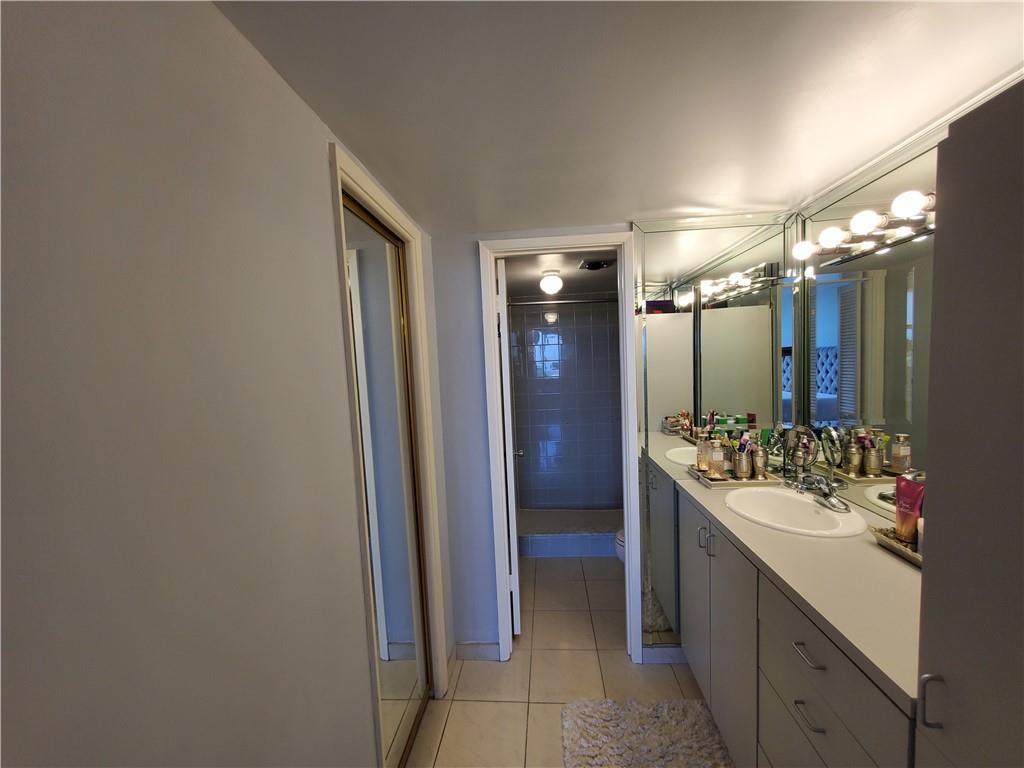 1401 North Riverside Drive, Unit 1503 Pompano Beach, FL 33062 - Photo 26 of 34 a bathroom with a sink vanity and a mirror