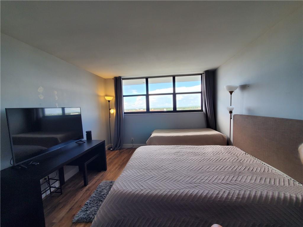 1401 North Riverside Drive, Unit 1503 Pompano Beach, FL 33062 - Photo 27 of 34 a bedroom with a large bed and a flat screen tv