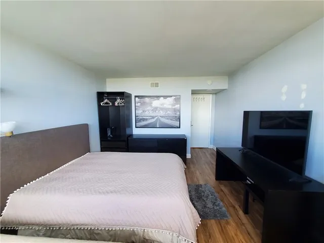 a large bed sitting in a bedroom and dresser