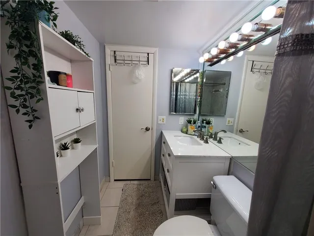 a bathroom with a sink mirror and toilet