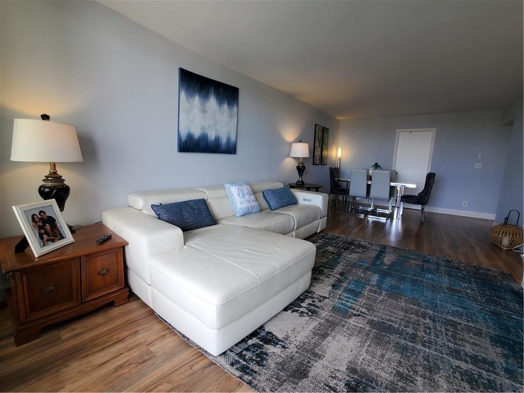 1401 North Riverside Drive, Unit 1503 Pompano Beach, FL 33062 - Photo 10 of 34 a living room with furniture and a lamp