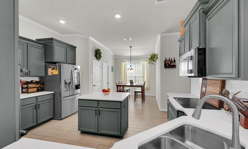 404 Calder Street Waco, TX 76712 - Photo 11 of 40 a kitchen with stainless steel appliances granite countertop a sink refrigerator and cabinets