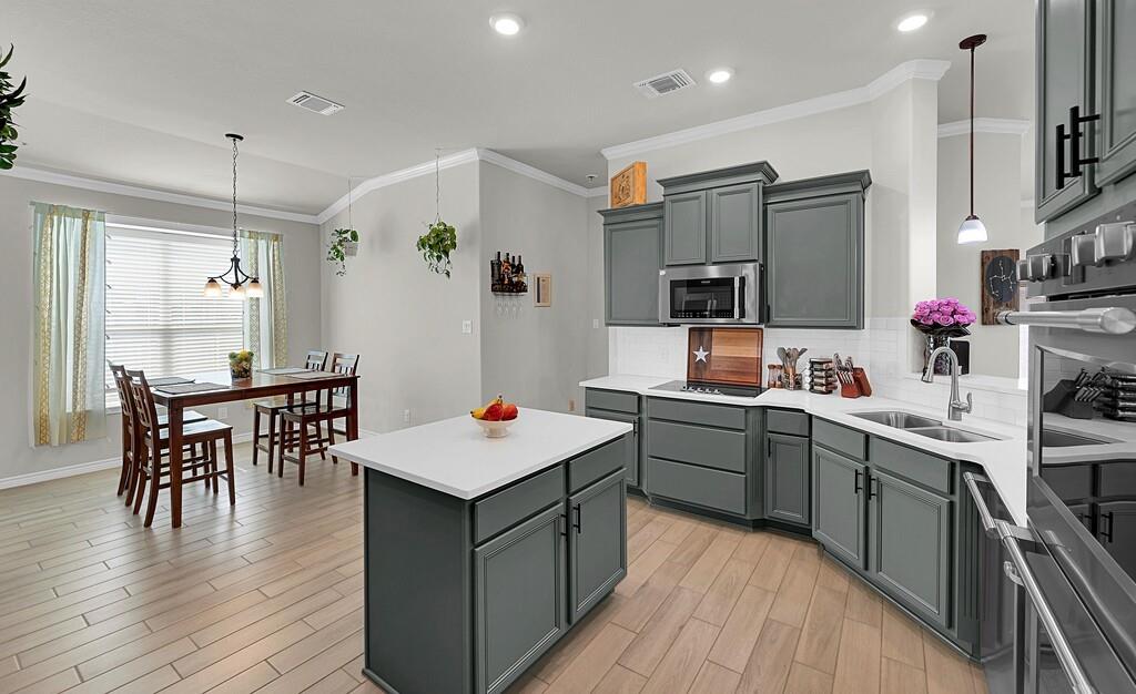 404 Calder Street Waco, TX 76712 - Photo 12 of 40 a kitchen with a sink a counter top space stainless steel appliances and cabinets