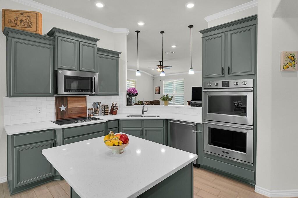 404 Calder Street Waco, TX 76712 - Photo 13 of 40 a kitchen with stainless steel appliances a stove a sink a microwave a refrigerator and cabinets