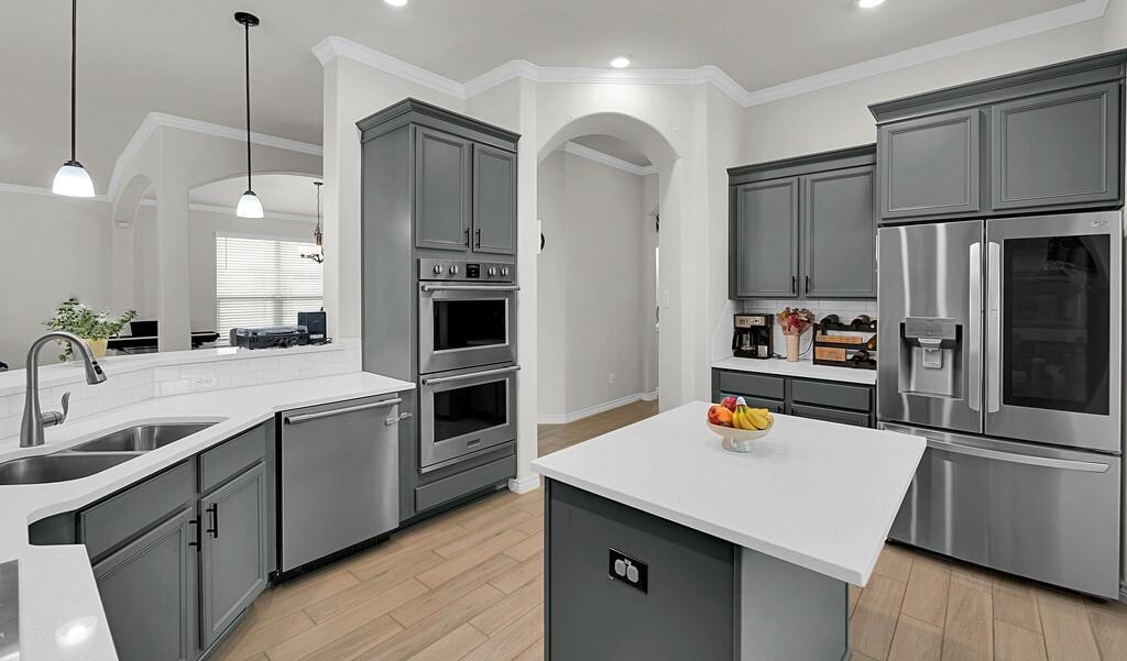 404 Calder Street Waco, TX 76712 - Photo 15 of 40 a kitchen with stainless steel appliances a sink a stove a refrigerator and cabinets
