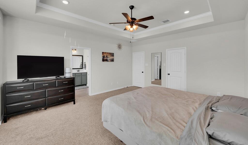 404 Calder Street Waco, TX 76712 - Photo 20 of 40 a bedroom with a bed and a flat screen tv