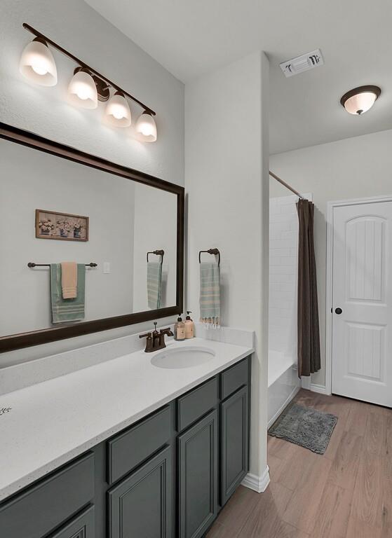 404 Calder Street Waco, TX 76712 - Photo 25 of 40 a bathroom with a sink and a mirror