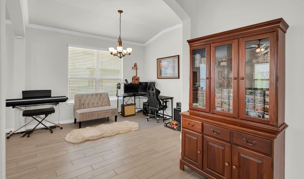 404 Calder Street Waco, TX 76712 - Photo 8 of 40 a living room with furniture windows and a wooden floor