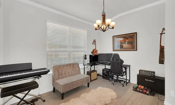a living room with furniture a piano and a window
