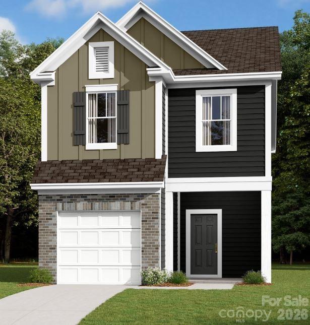 1153 Overbrook Place Wingate, NC 28174 - Photo 1 of 6 a front view of a house with a yard and garage