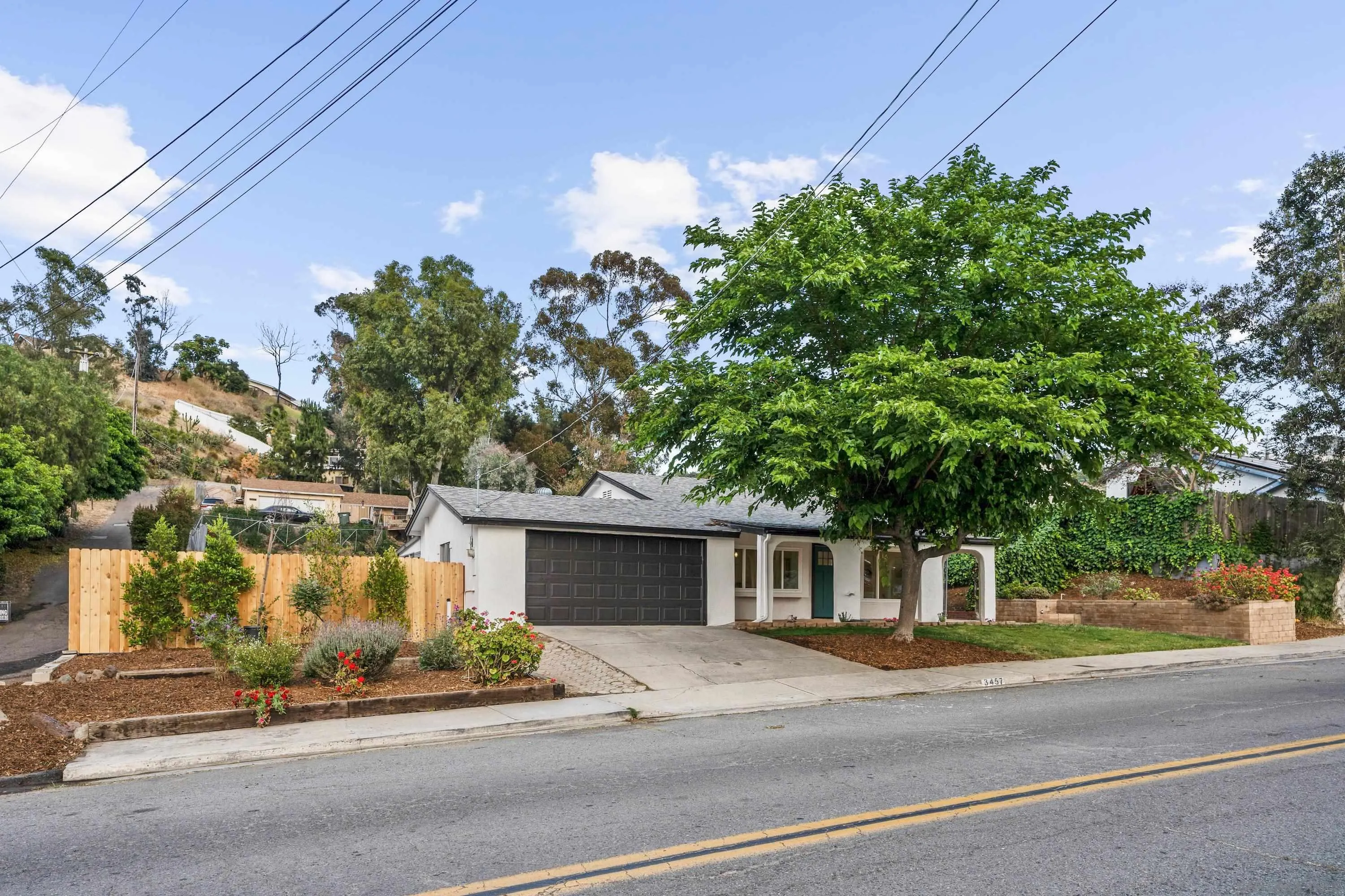 a front view of a house with a garden