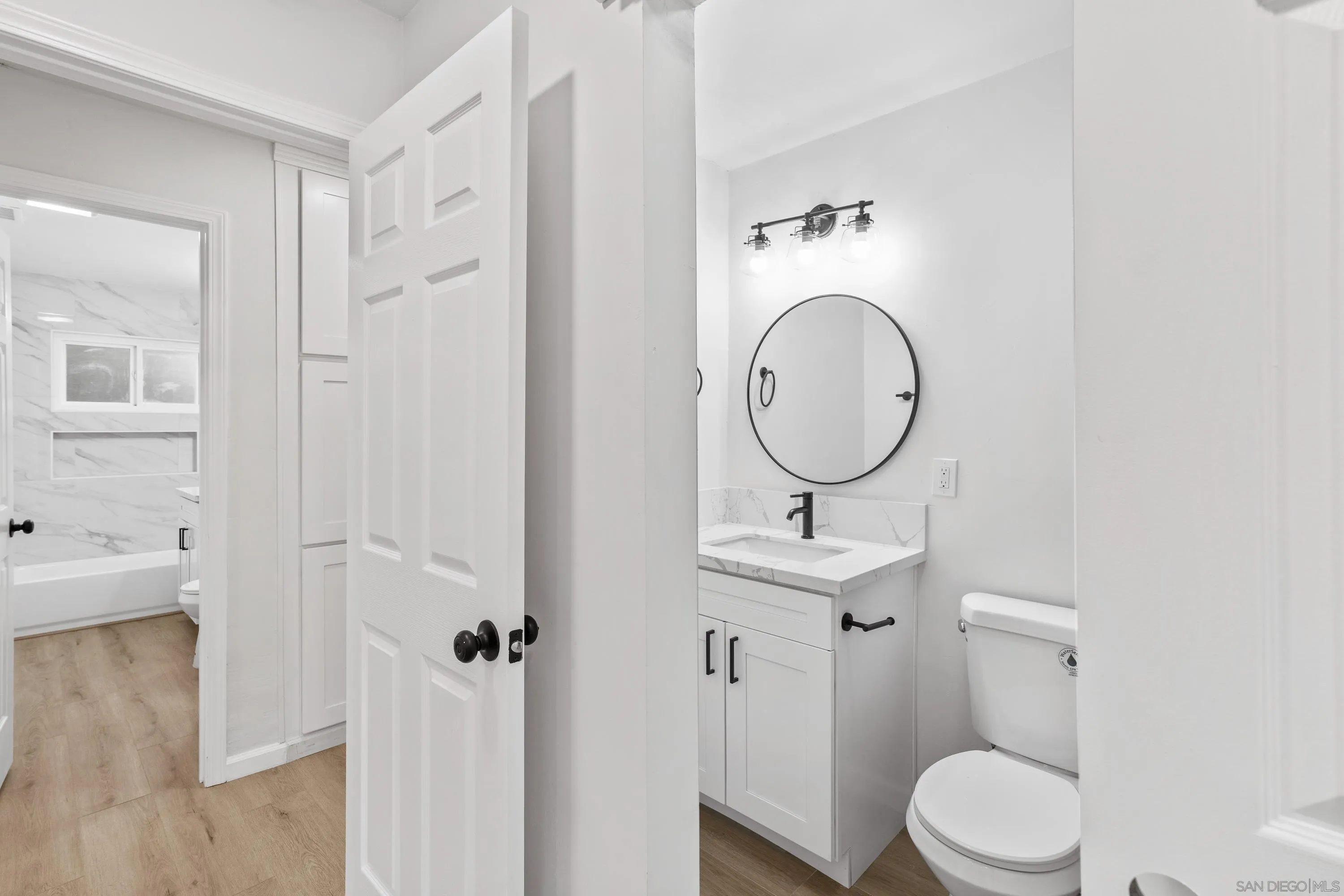 3457 Kenora Drive Spring Valley, CA 91977 - Photo 18 of 26 a bathroom with a toilet sink and mirror