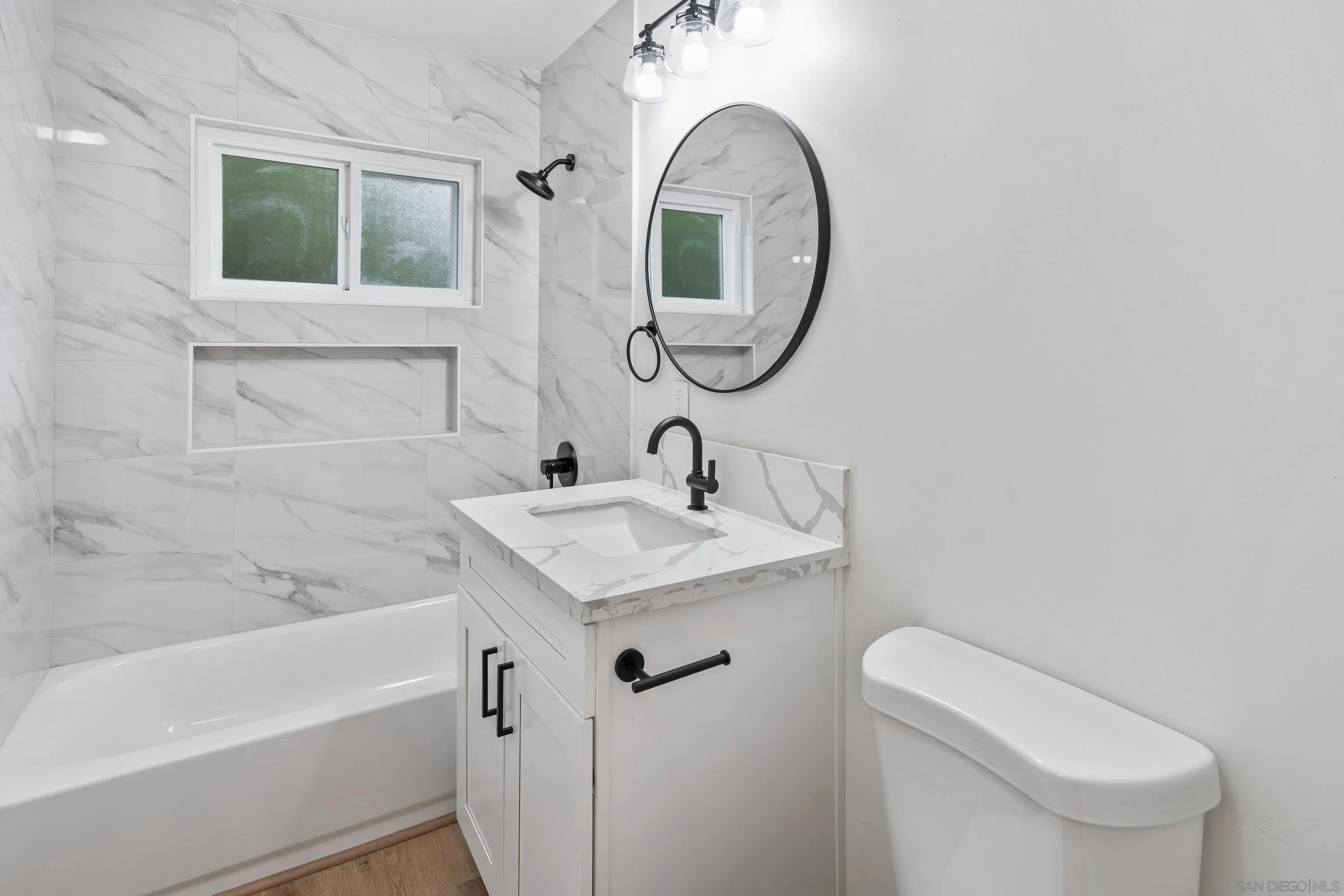 3457 Kenora Drive Spring Valley, CA 91977 - Photo 20 of 26 a bathroom with a sink a toilet and a mirror
