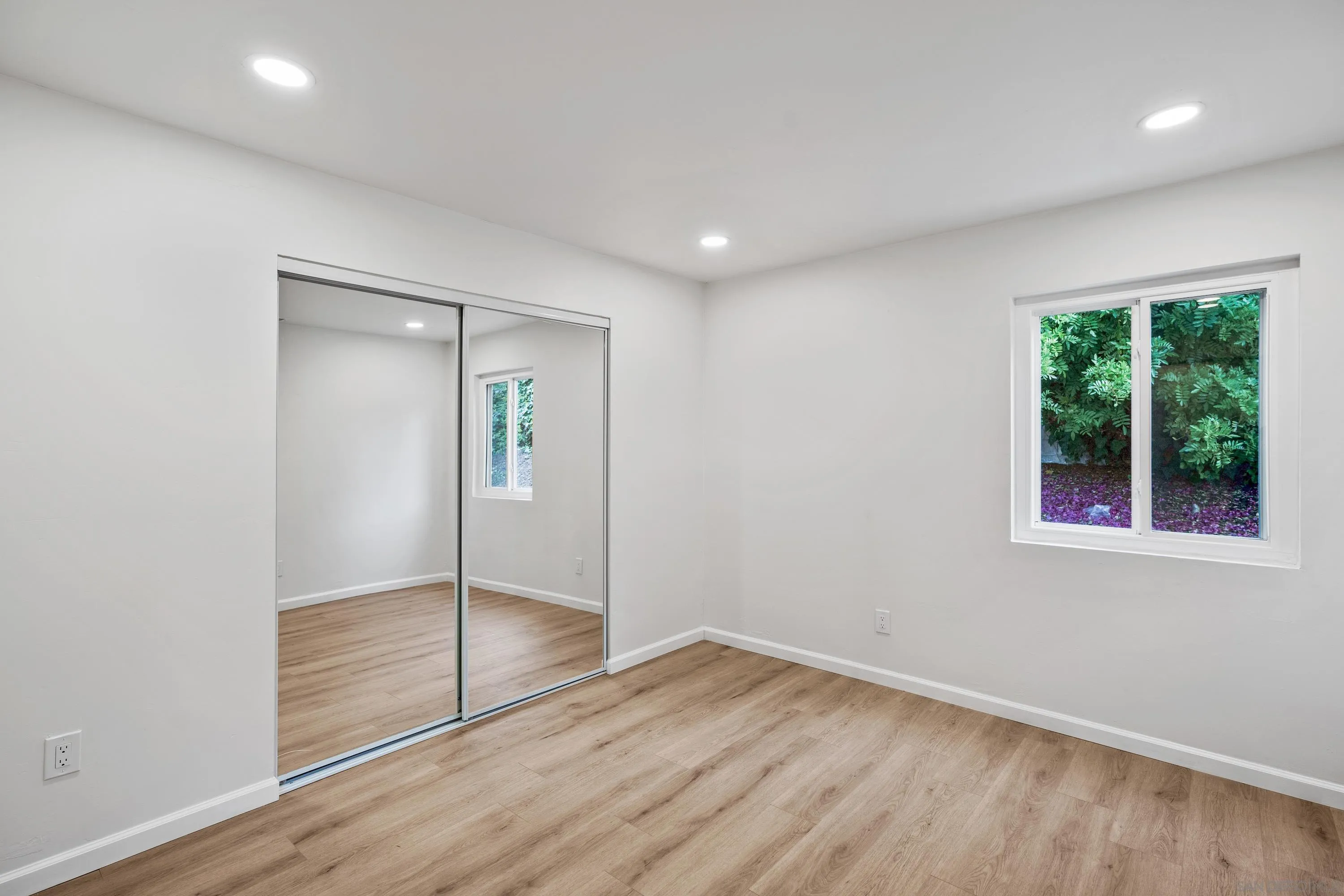 3457 Kenora Drive Spring Valley, CA 91977 - Photo 21 of 26 an empty room with wooden floor and windows
