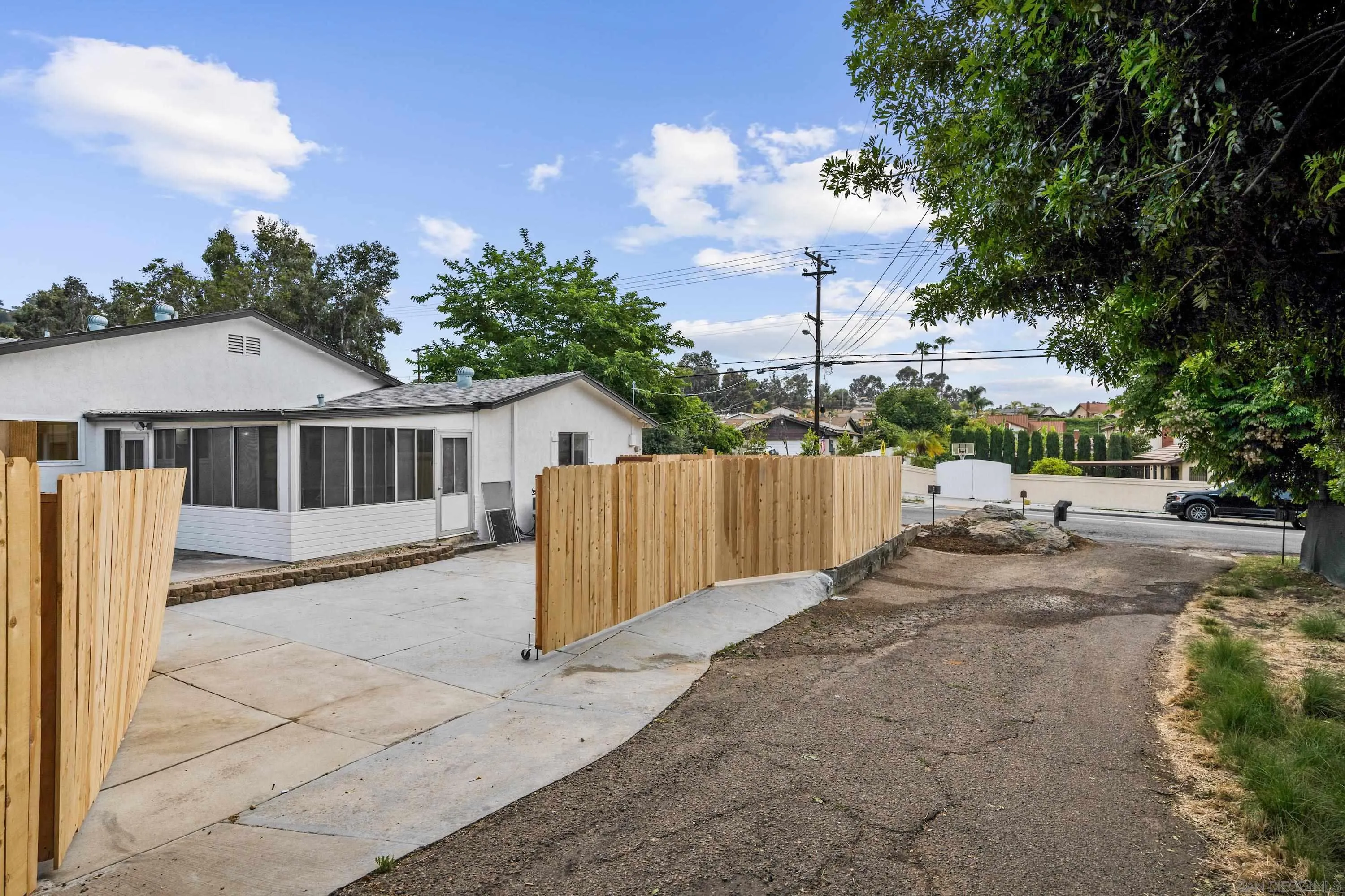 3457 Kenora Drive Spring Valley, CA 91977 - Photo 24 of 26 a view of a house with a small yard and wooden fence
