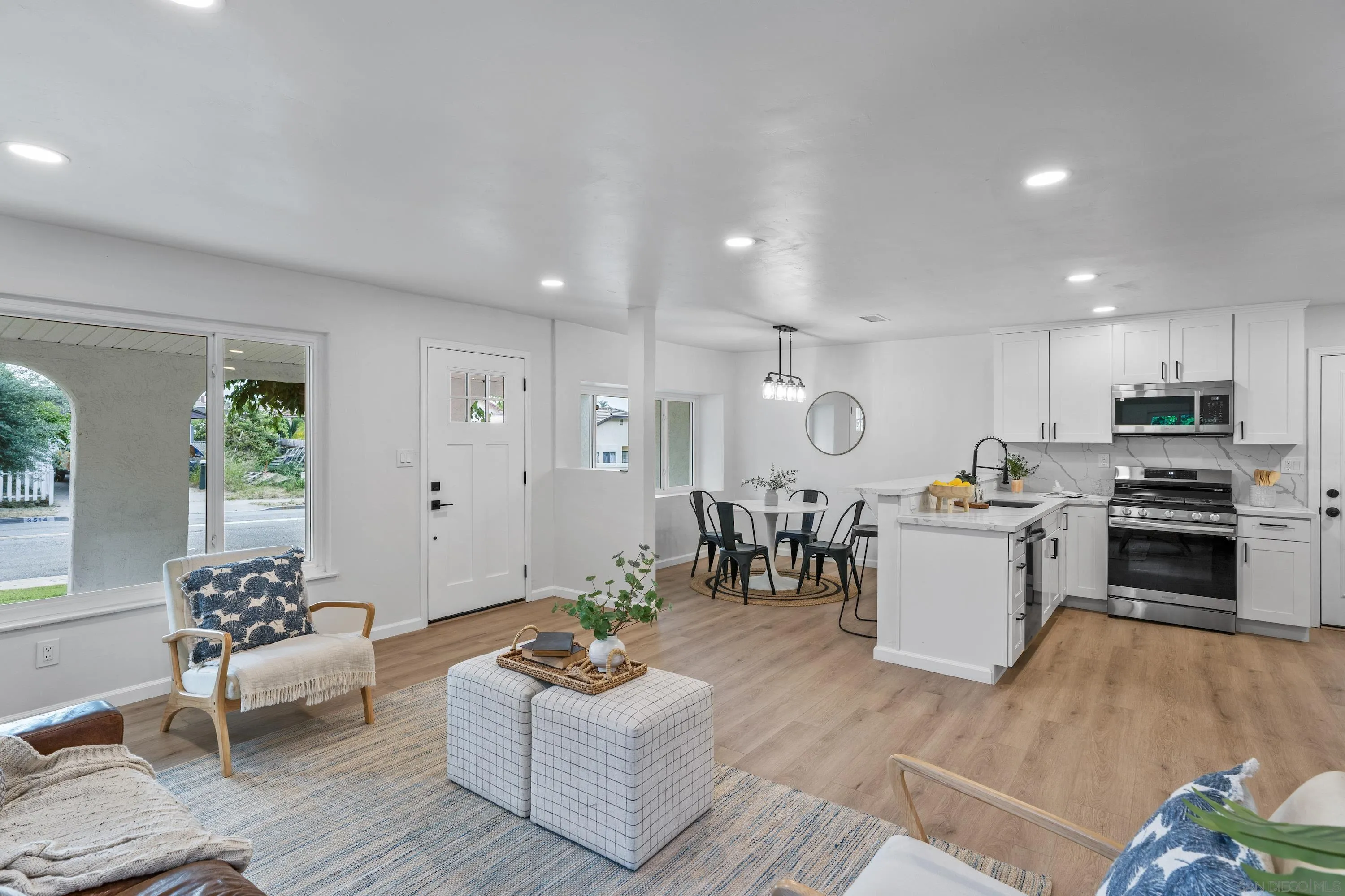 3457 Kenora Drive Spring Valley, CA 91977 - Photo 4 of 26 a living room with furniture kitchen view and a wooden floor