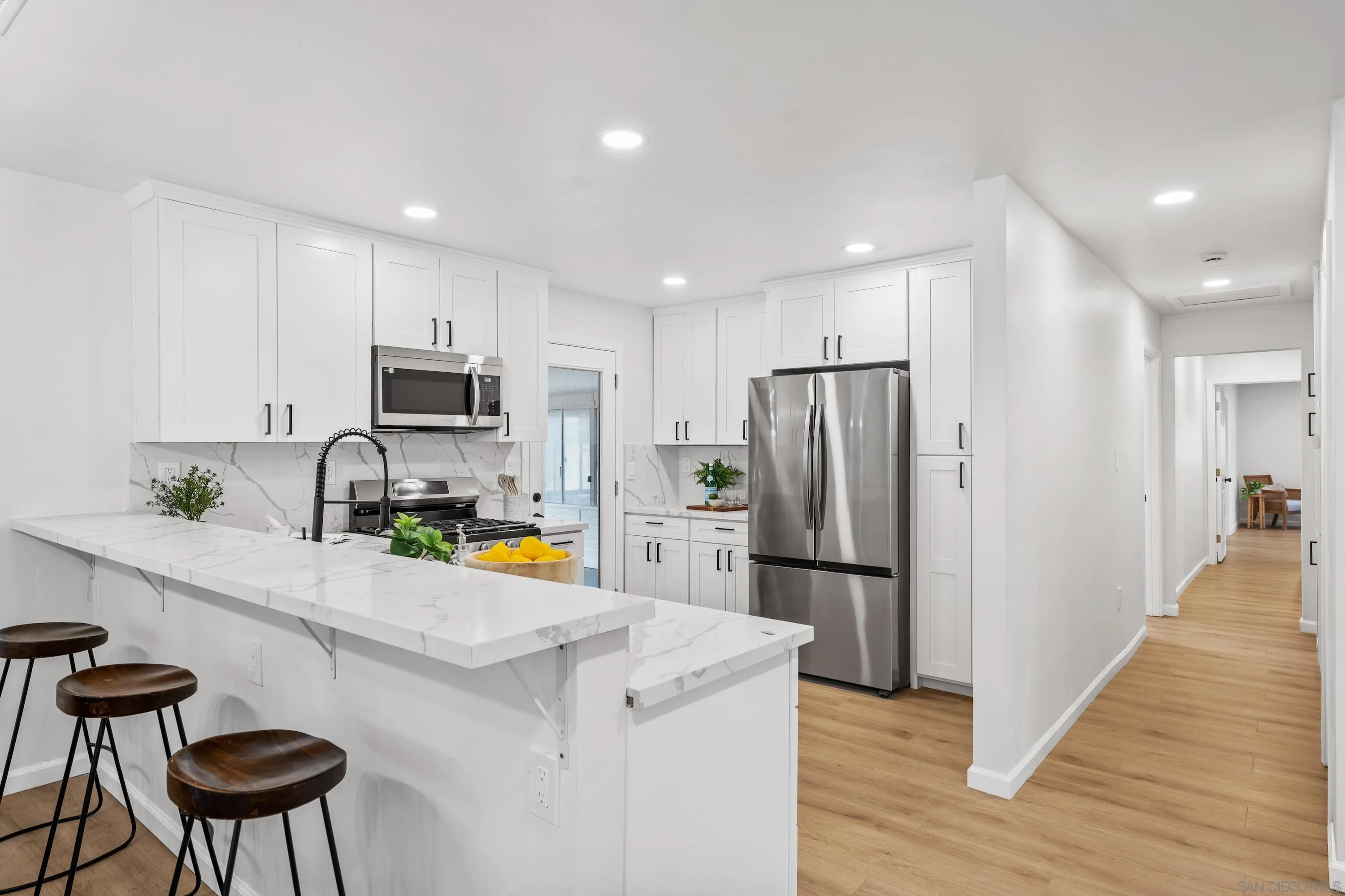 3457 Kenora Drive Spring Valley, CA 91977 - Photo 7 of 26 a kitchen with a refrigerator a stove and a wooden cabinets