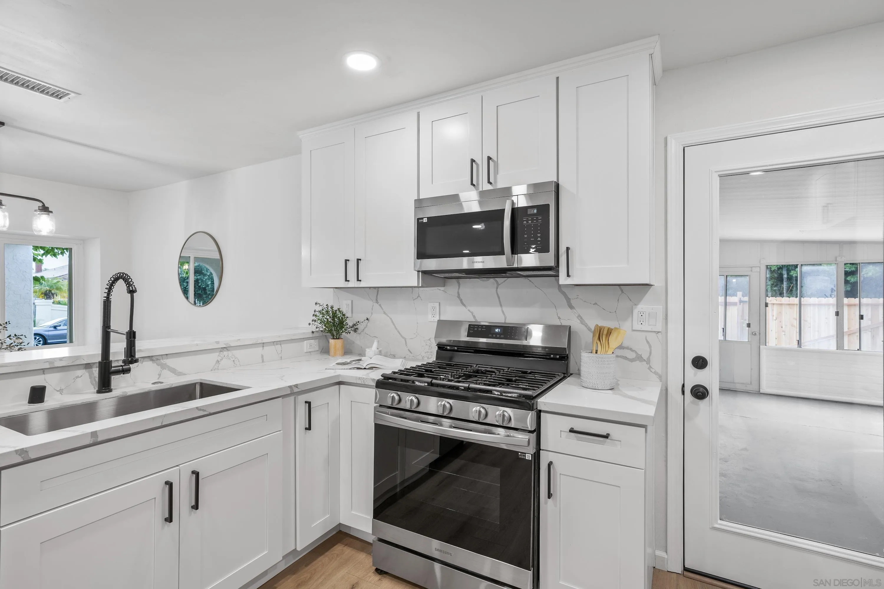 3457 Kenora Drive Spring Valley, CA 91977 - Photo 9 of 26 a kitchen with stainless steel appliances white cabinets and a sink
