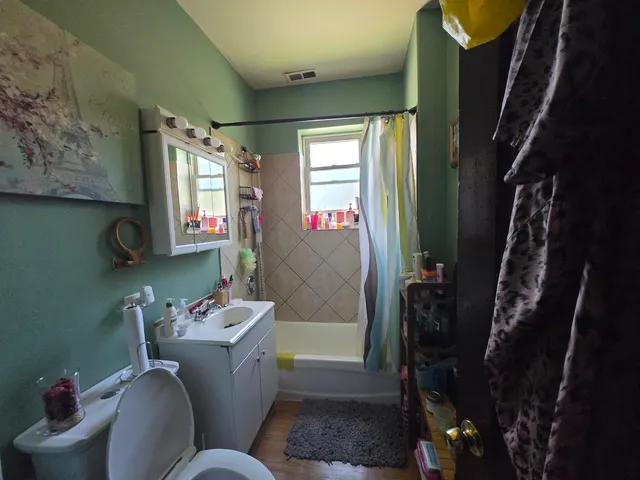 a bathroom with a sink mirror vanity and toilet