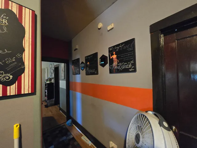 a kitchen with lots of clutter and cabinets