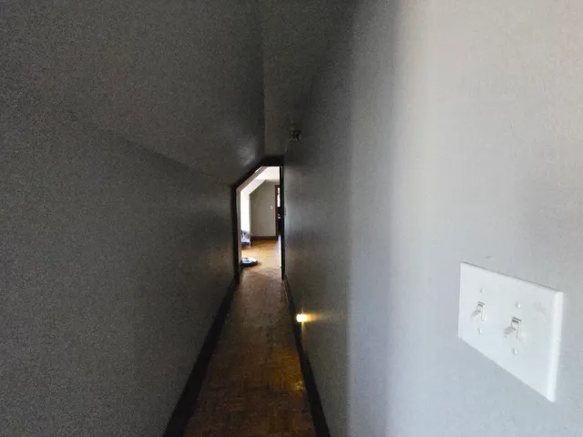 a view of a livingroom with workspace and a flat screen tv