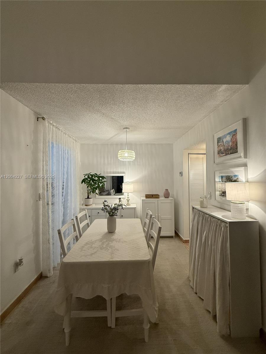 15650 Southwest 80th Street, Unit F208 Miami, FL 33193 - Photo 11 of 19 a view of a dining room with furniture