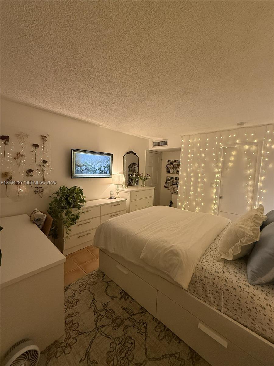 15650 Southwest 80th Street, Unit F208 Miami, FL 33193 - Photo 18 of 19 a bedroom with a bed and window
