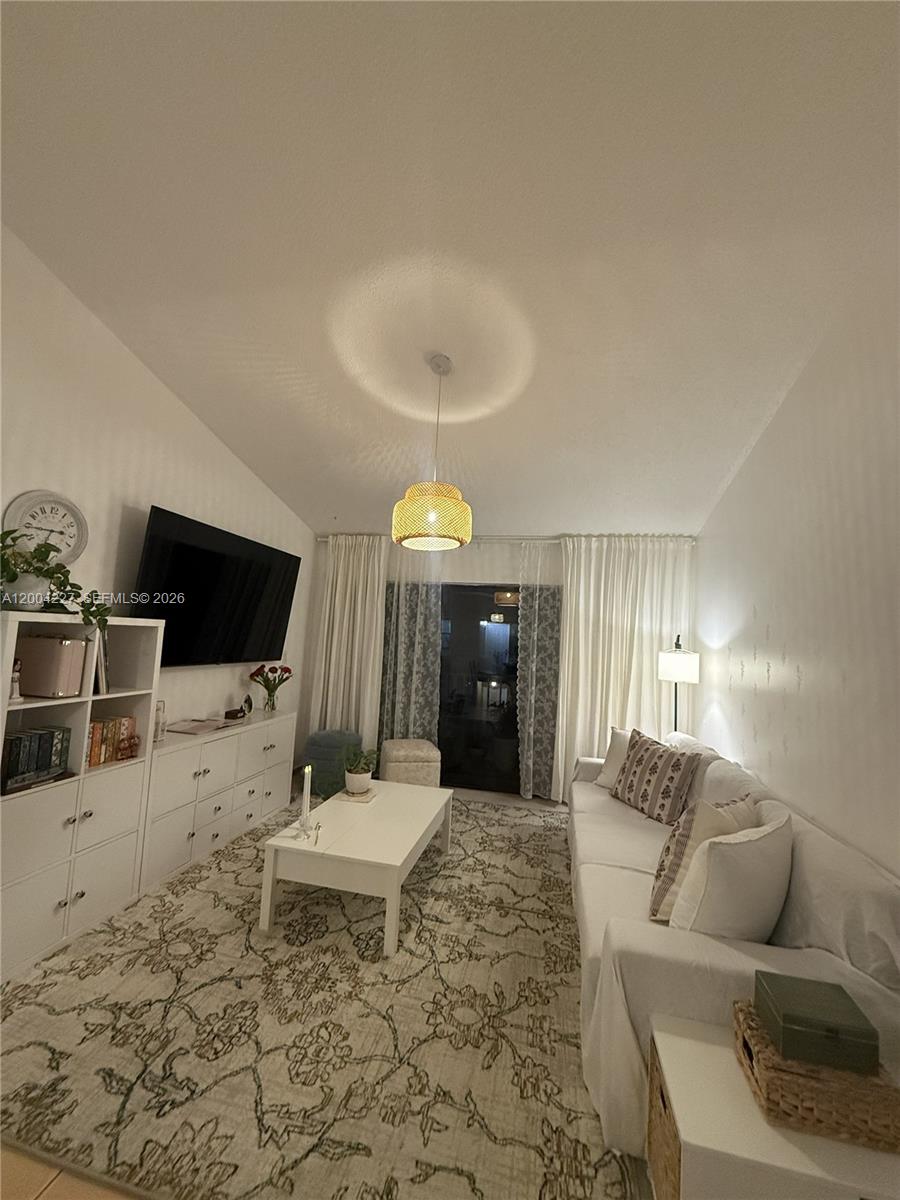 15650 Southwest 80th Street, Unit F208 Miami, FL 33193 - Photo 6 of 19 a living room with furniture and a flat screen tv