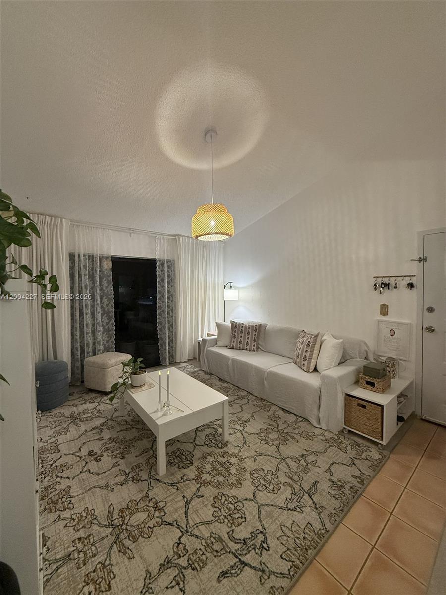 15650 Southwest 80th Street, Unit F208 Miami, FL 33193 - Photo 7 of 19 a living room with furniture and a flat screen tv