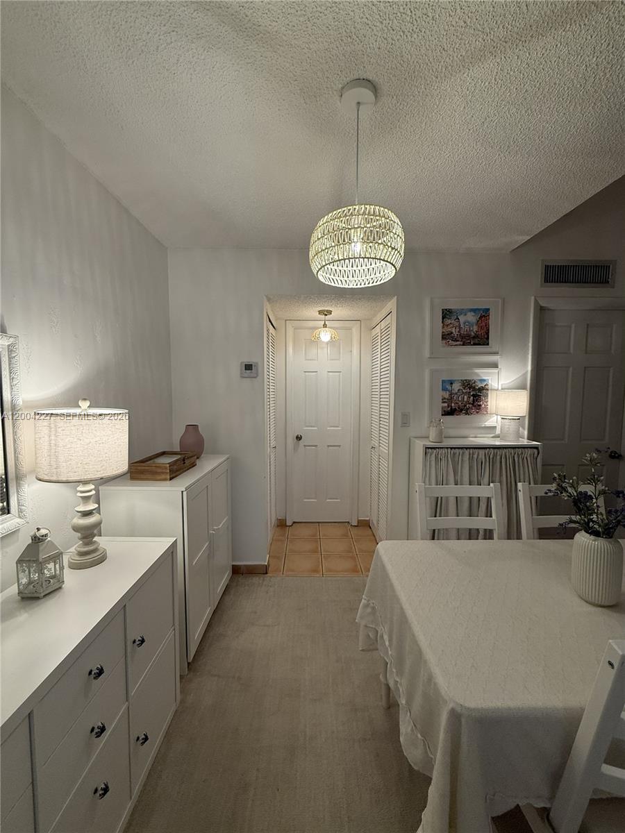 15650 Southwest 80th Street, Unit F208 Miami, FL 33193 - Photo 8 of 19 a kitchen with stainless steel appliances a dining table chairs and stove