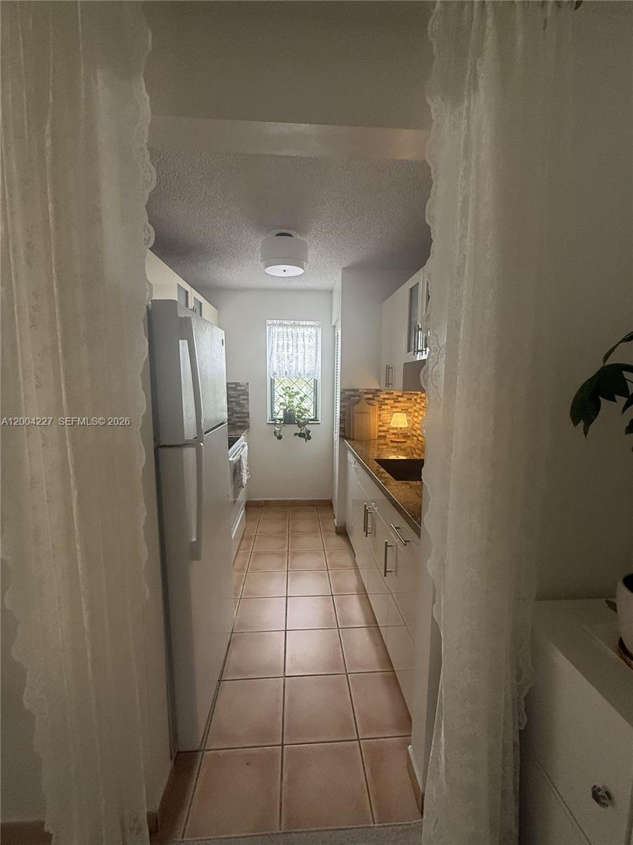 15650 Southwest 80th Street, Unit F208 Miami, FL 33193 - Photo 10 of 19 a view of hallway with cabinets