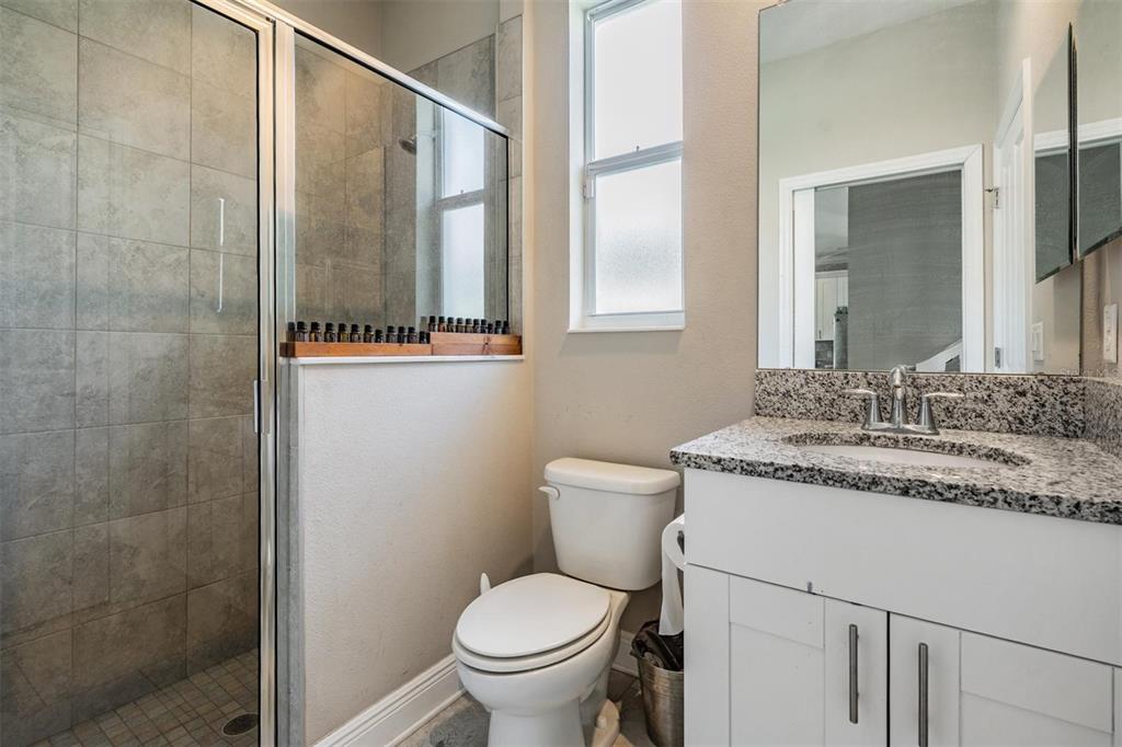 3016 Alachua Place New Port Richey, FL 34655 - Photo 14 of 65 a bathroom with a granite countertop sink toilet and shower
