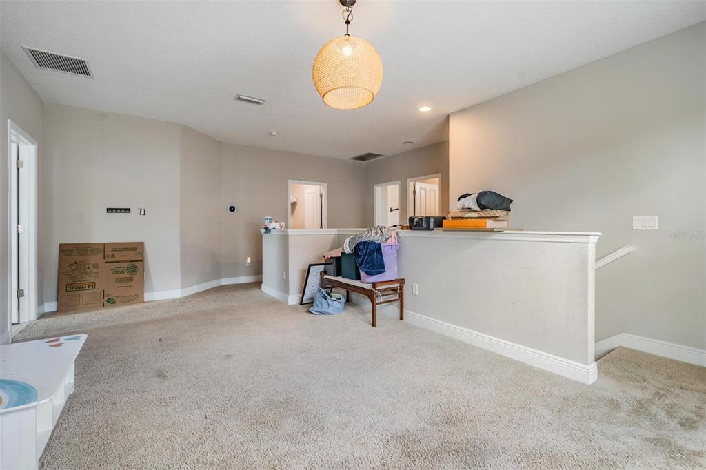 3016 Alachua Place New Port Richey, FL 34655 - Photo 24 of 65 a living room with furniture and a chandelier