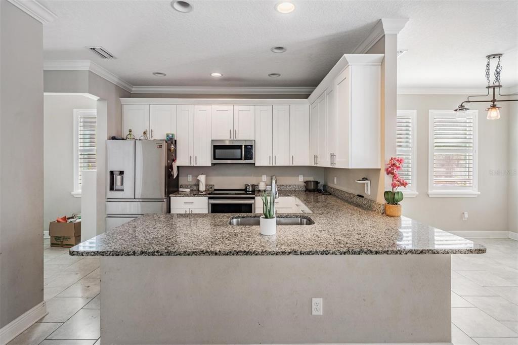 3016 Alachua Place New Port Richey, FL 34655 - Photo 4 of 65 a kitchen with stainless steel appliances granite countertop a sink stove and refrigerator