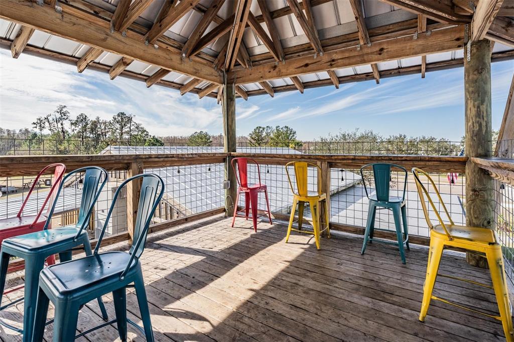 3016 Alachua Place New Port Richey, FL 34655 - Photo 60 of 65 a view of a balcony with wooden floor and outdoor seating