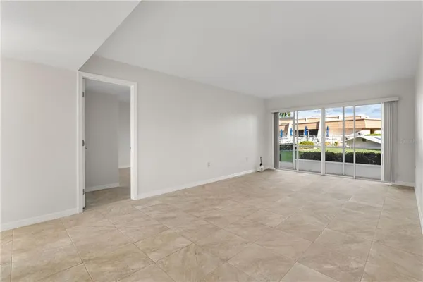 an empty room with floor to ceiling window and an empty room