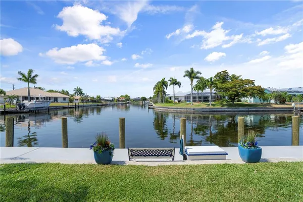 a view of a house with a yard and lake view