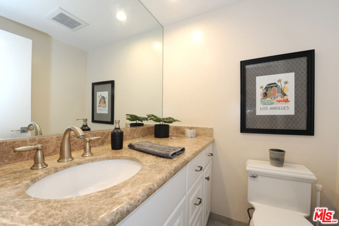 4 Lighthouse Street, Unit 5 Marina del Rey, CA 90292 - Photo 13 of 25 a bathroom with a granite countertop sink and a mirror