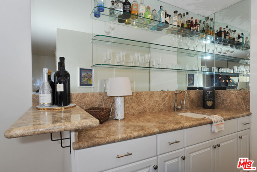 4 Lighthouse Street, Unit 5 Marina del Rey, CA 90292 - Photo 9 of 25 a kitchen with kitchen island granite countertop a sink and cabinets