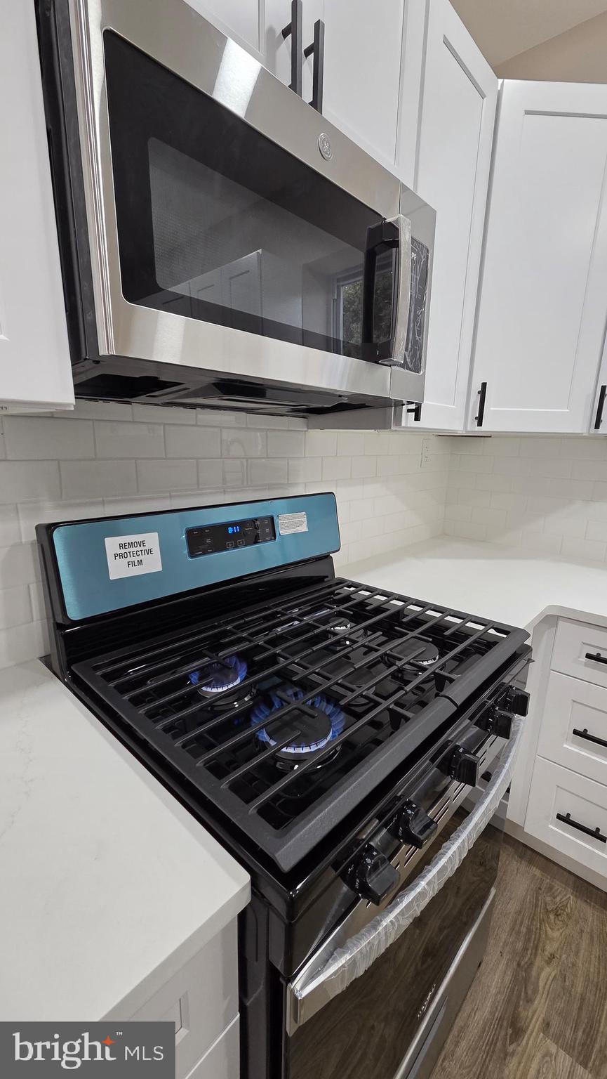 5706 Vandike Street Philadelphia, PA 19135 - Photo 12 of 32 a stove top oven sitting inside of a kitchen