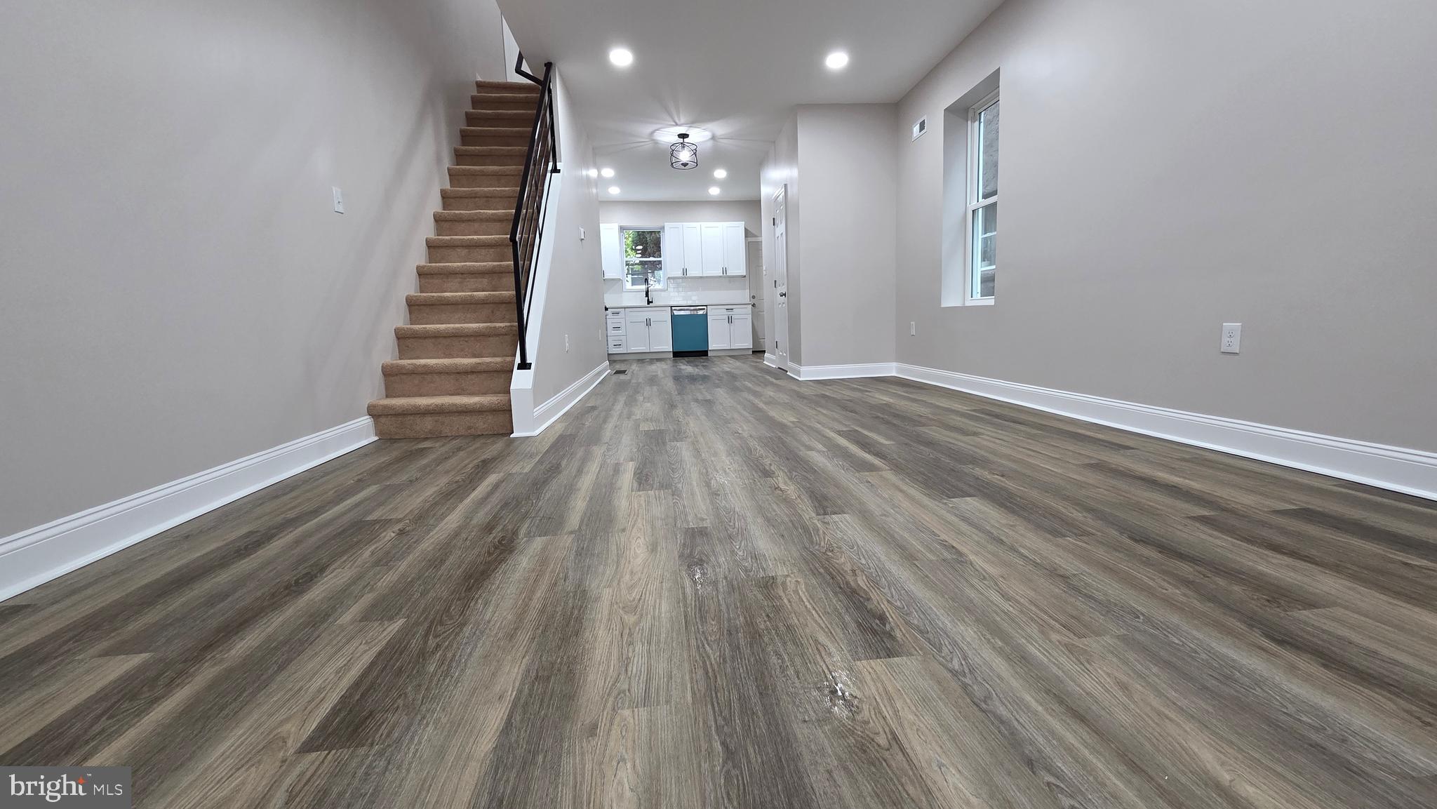 5706 Vandike Street Philadelphia, PA 19135 - Photo 8 of 32 a view of a room with wooden floor and stairs